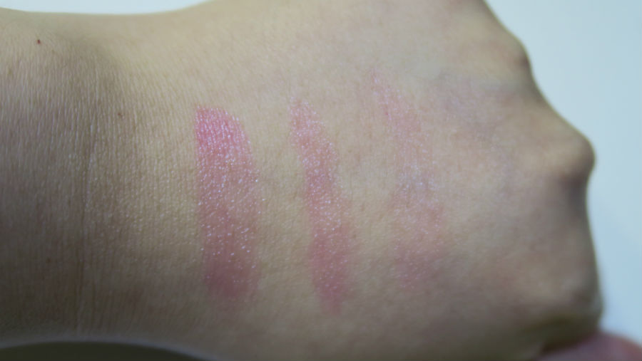 It goes on clear at first (swatch on the right), then gradually becomes a deeper shade of pink (swatch in middle, then swatch on right).
